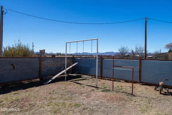 a view of a backyard with table and chairs