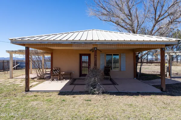 a view of a house with backyard porch and sitting area