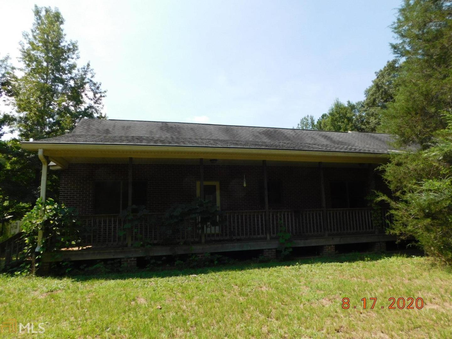 6487 Hopewell Road, Unit B4 Culloden, GA 31016 - Photo 1 of 1 a front view of a house with a garden