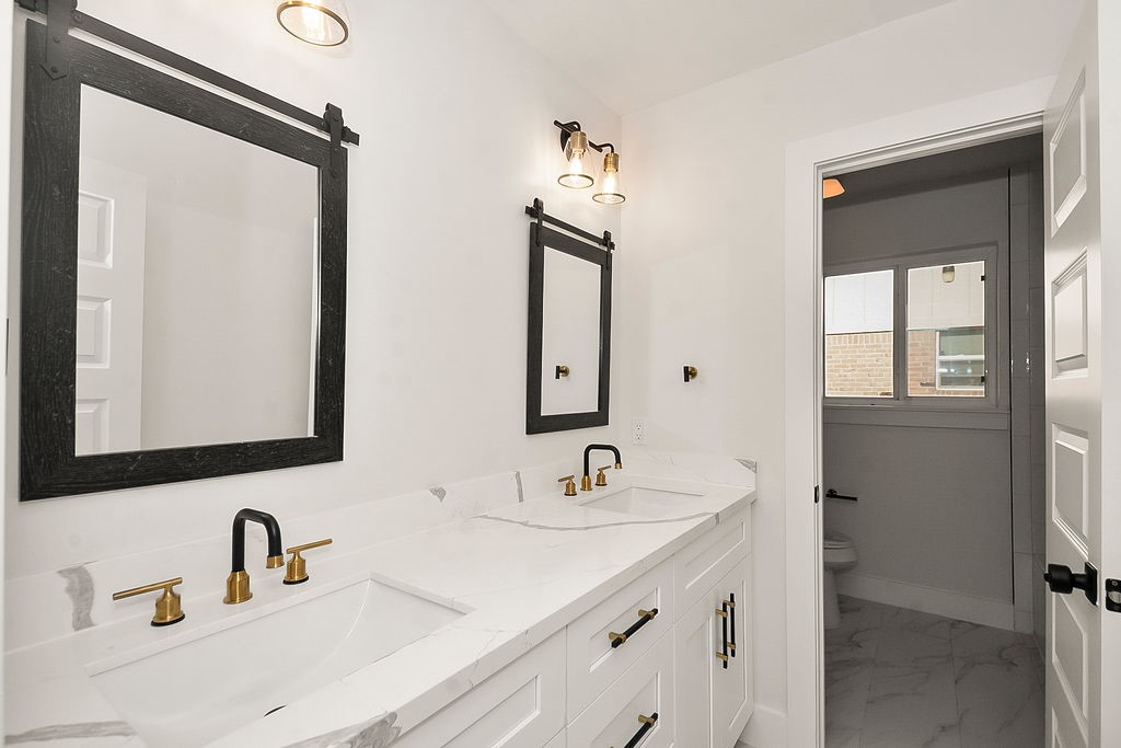 6106 Rutherglenn Drive Houston, TX 77096 - Photo 36 of 41 Stylishly updated bathroom vanity with modern fixtures and contemporary design details.