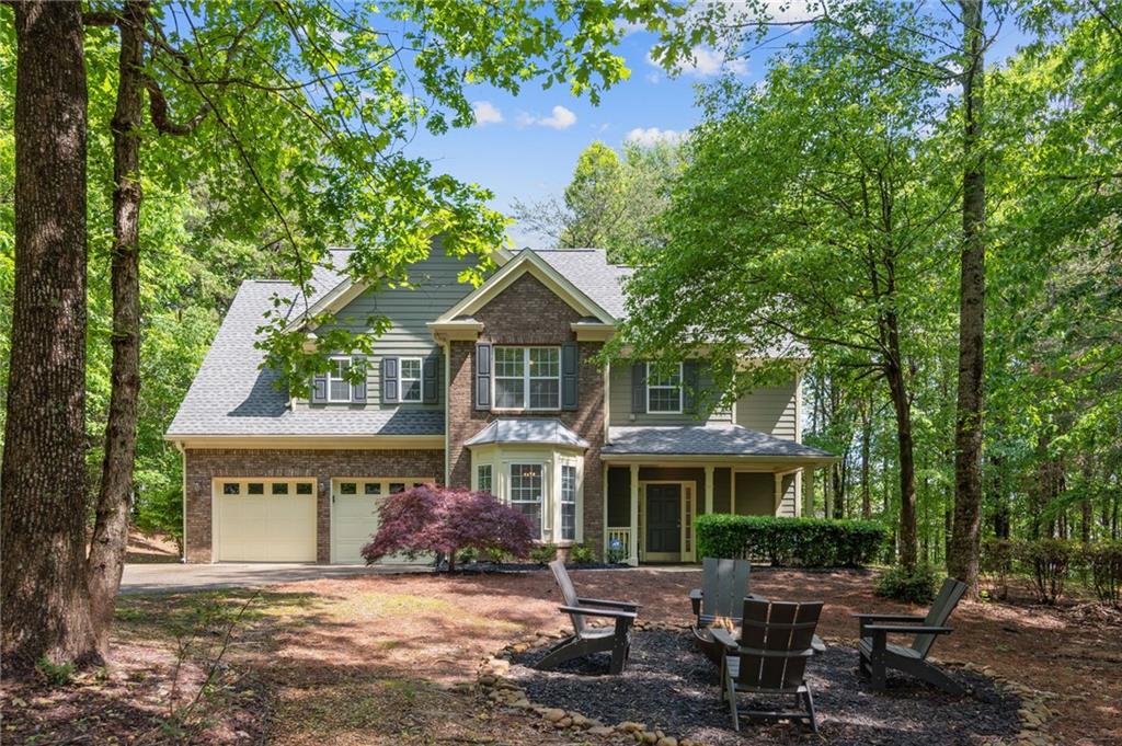a front view of a house with a garden