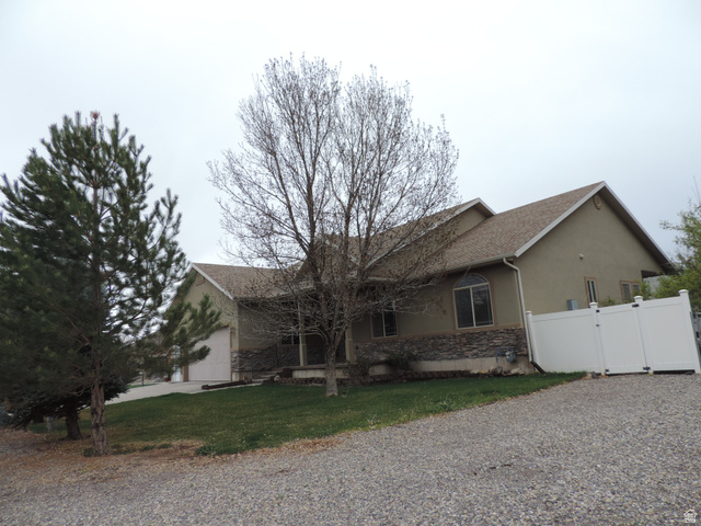 140 North 200 E Street Glenwood, UT 84730 - Photo 2 of 54 View of property exterior featuring stucco siding, stone siding, a gate, driveway, and a garage