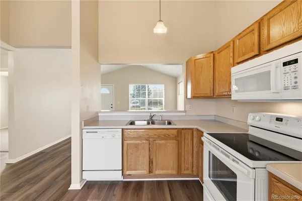 a kitchen with a sink a stove and cabinets