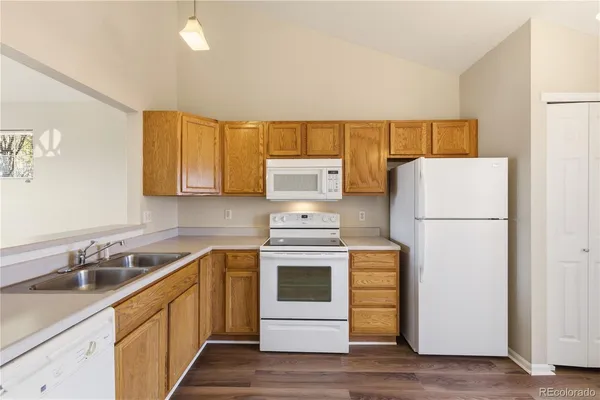 a kitchen with a stove a refrigerator and a sink