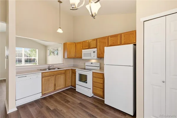 a kitchen with stainless steel appliances a refrigerator sink and microwave