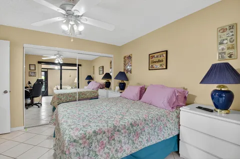 a bedroom with a bed a chandelier and dresser