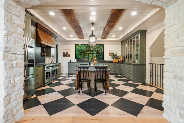 1141 South Oak Leaf Lane Springville, UT 84663 - Photo 42 of 147 Gourmet kitchen featuring a large central island, professional-grade range with a custom wood hood, built-in refrigerator, checkerboard flooring, and exposed ceiling beams