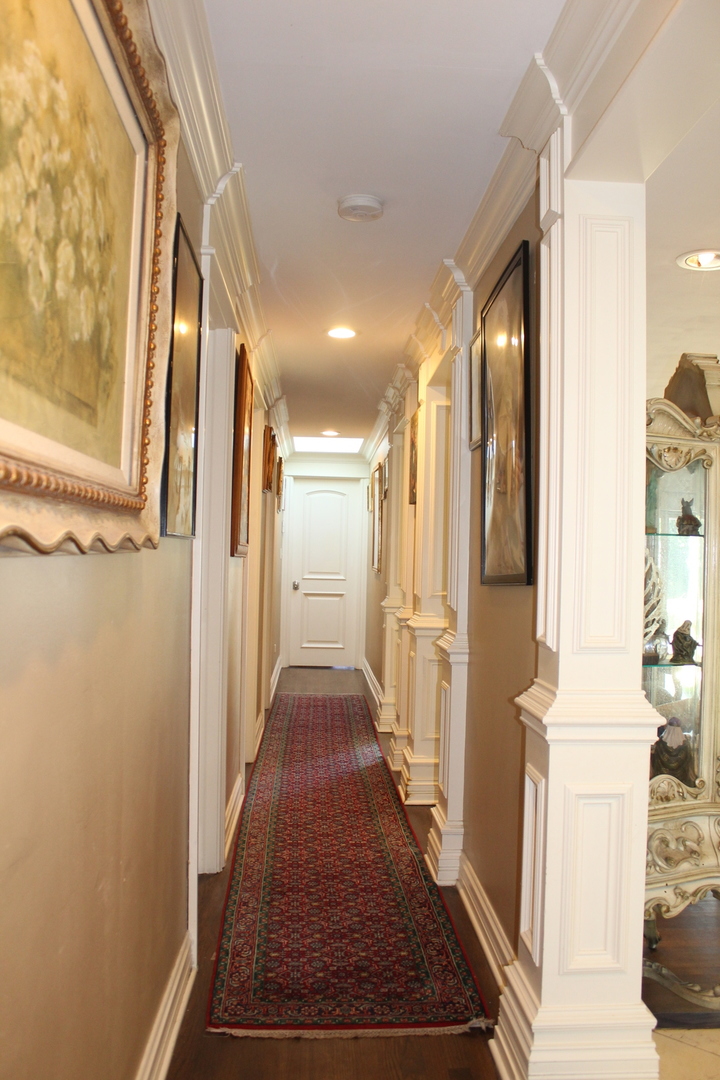 2290 Cedar Court Northbrook, IL 60062 - Photo 37 of 47 a view of a hallway with wooden floor and staircase