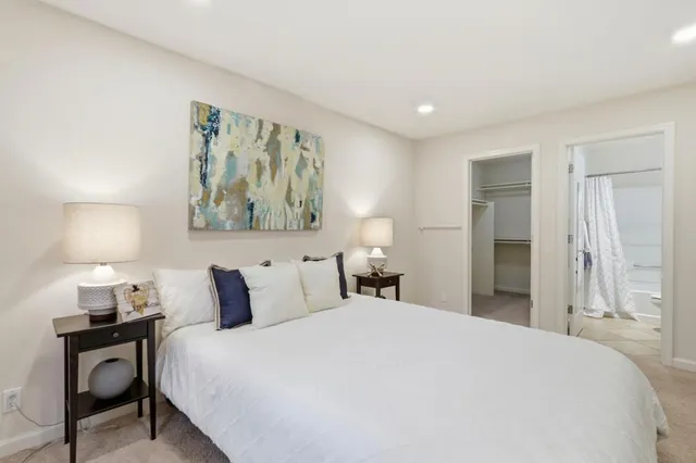 a bedroom with a bed and a painting on the wall