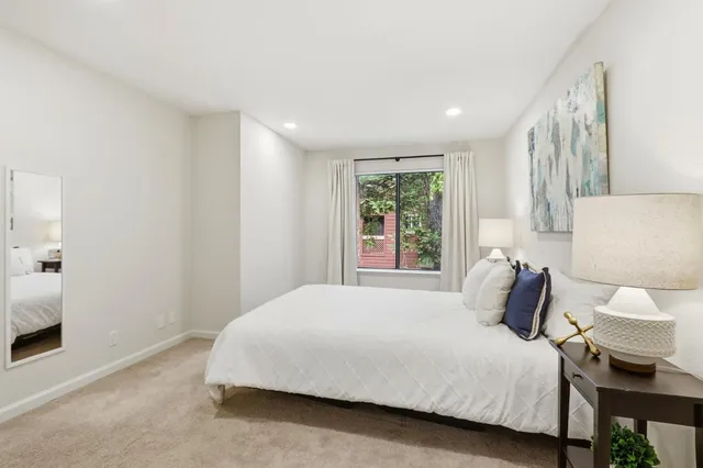 a bedroom with a bed and window