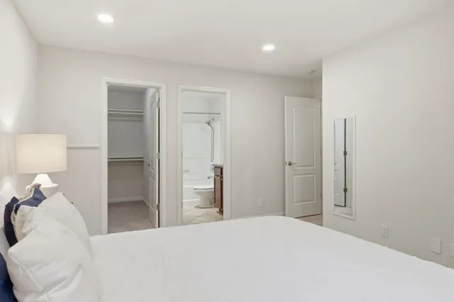 a bedroom with a bed and a lamp