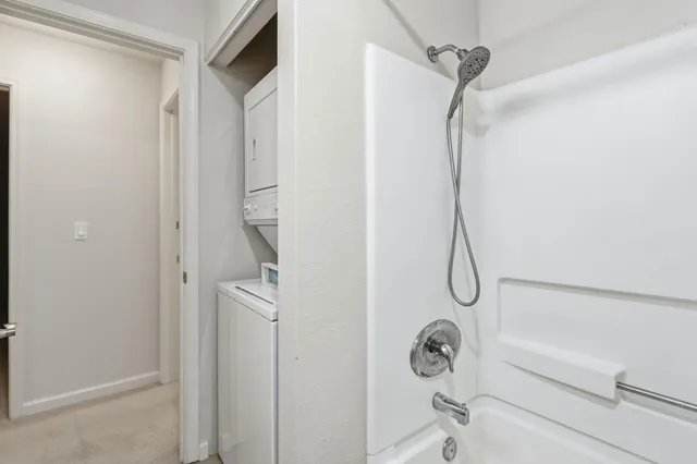 a bathroom with a shower a bath tub and a shower