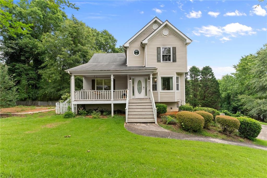 4010 Catawba Ridge Gainesville, GA 30506 - Photo 1 of 1 a front view of a house with a garden and yard