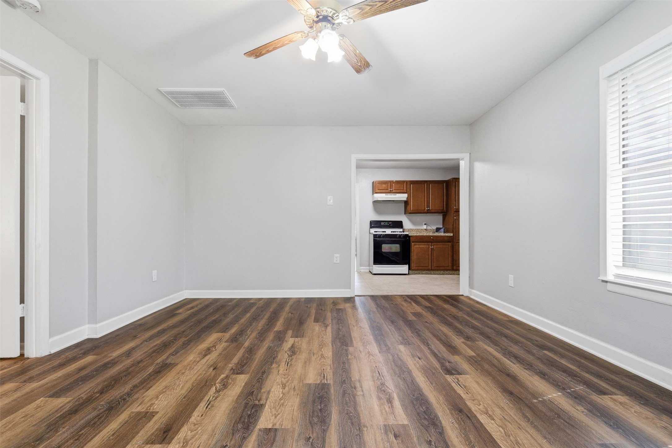 3615 Alberta Street Houston, TX 77021 - Photo 7 of 16 a view of an empty room with a window and a kitchen