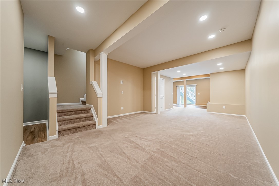 5270 Brainard Road Solon, OH 44139 - Photo 29 of 45 Unfurnished Walk-out basement living area featuring recessed lighting, at stairs, and with carpet flooring