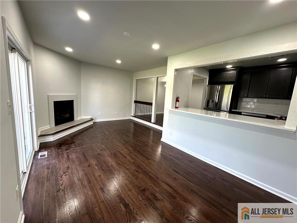 4204 Hana Road Edison, NJ 08817 - Photo 18 of 48 an empty room with wooden floor and fireplace