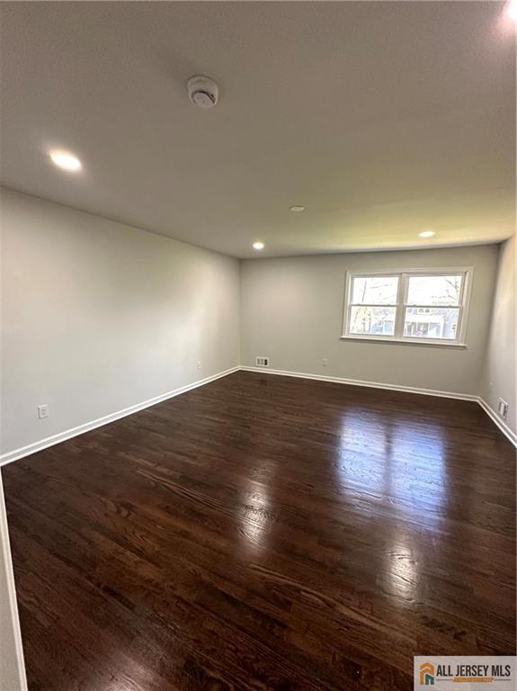 4204 Hana Road Edison, NJ 08817 - Photo 31 of 48 an empty room with wooden floor and windows