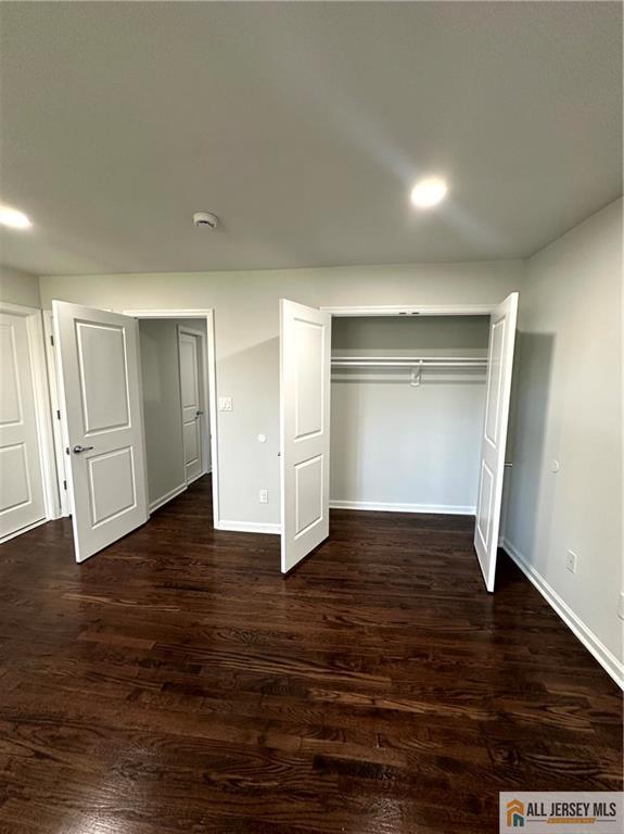 4204 Hana Road Edison, NJ 08817 - Photo 32 of 48 a view of an empty room with wooden floor and closet