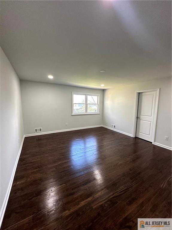 4204 Hana Road Edison, NJ 08817 - Photo 33 of 48 an empty room with wooden floor and windows