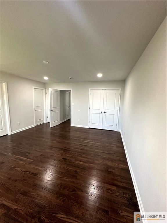 4204 Hana Road Edison, NJ 08817 - Photo 35 of 48 a view of an empty room with wooden floor and kitchen