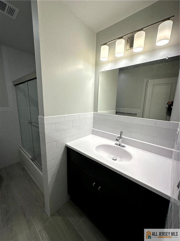 4204 Hana Road Edison, NJ 08817 - Photo 43 of 48 a bathroom with a sink vanity and mirror