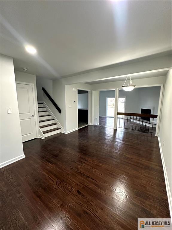4204 Hana Road Edison, NJ 08817 - Photo 6 of 48 a view of an empty room with wooden floor and stairs