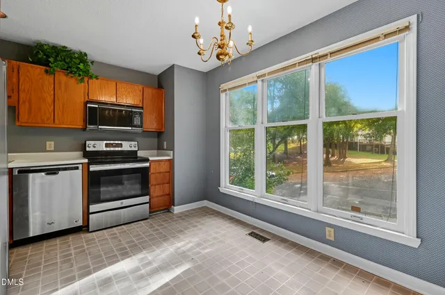 a view of kitchen with furniture stove and refrigerator