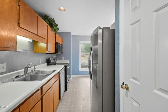 a kitchen with stainless steel appliances a stove a microwave sink and cabinets