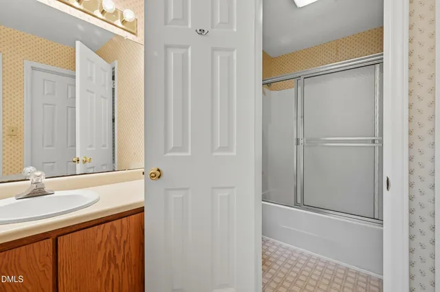 a bathroom with a double vanity sink and a mirror