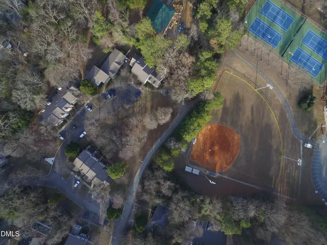 a view of an empty room with a ceiling fan and window