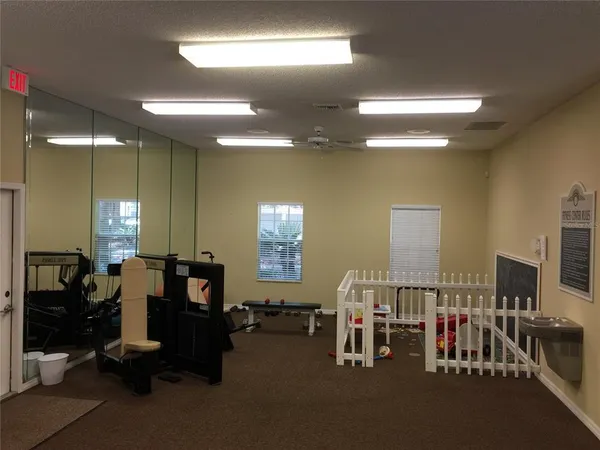 a living room with lots of chairs and gym equipment