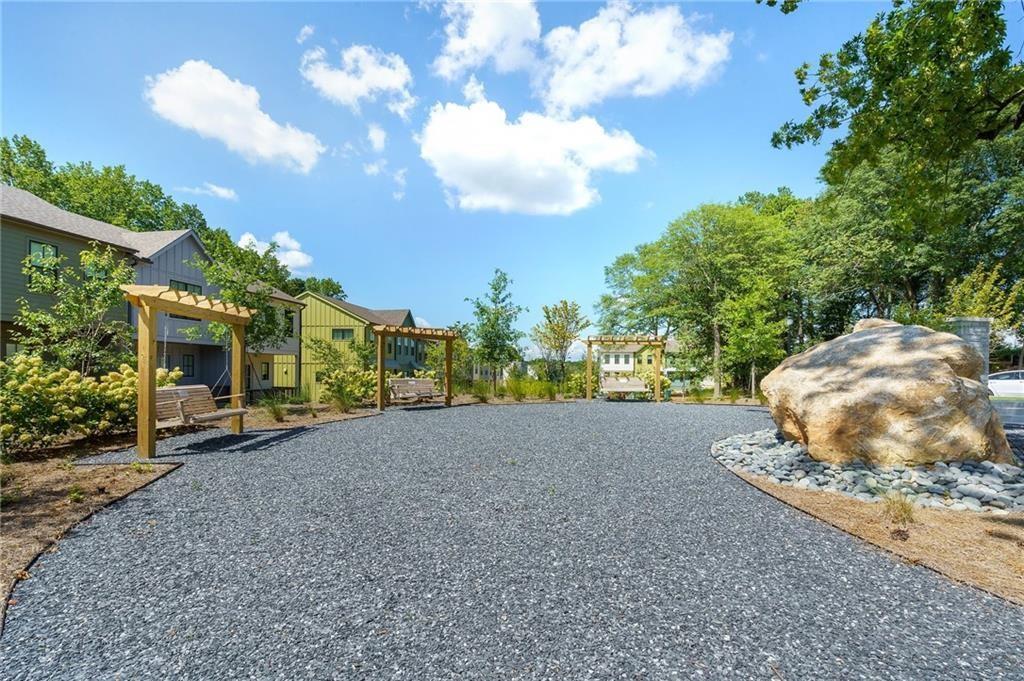 1416 Hazy Way Street Southeast, Unit 317 Atlanta, GA 30315 - Photo 16 of 20 a view of a house with a yard and street