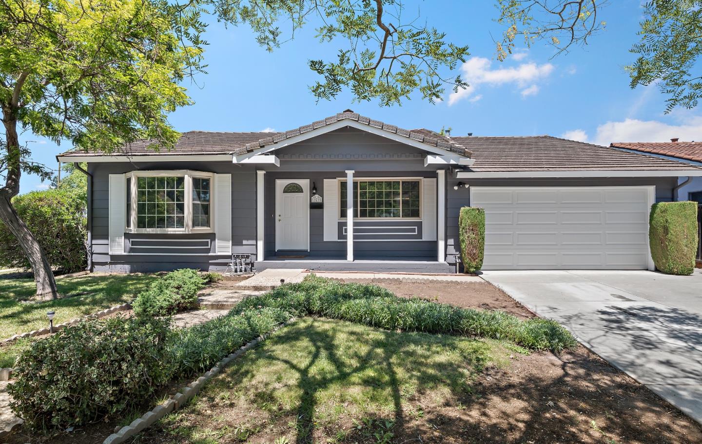 a front view of a house with garden