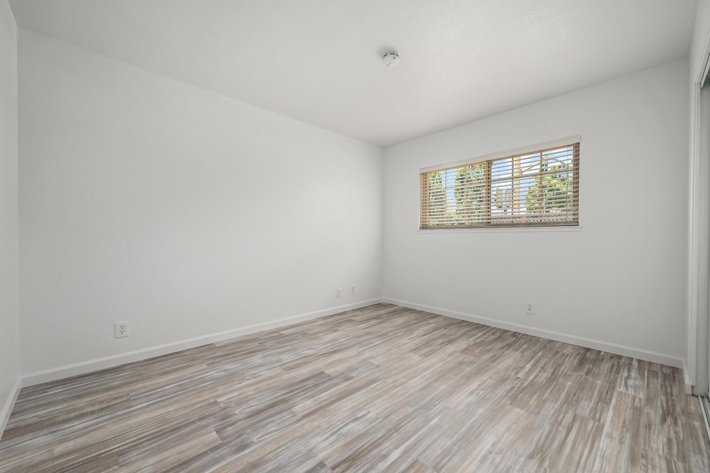 929 Maclay Drive San Jose, CA 95123 - Photo 16 of 23 an empty room with wooden floor and windows