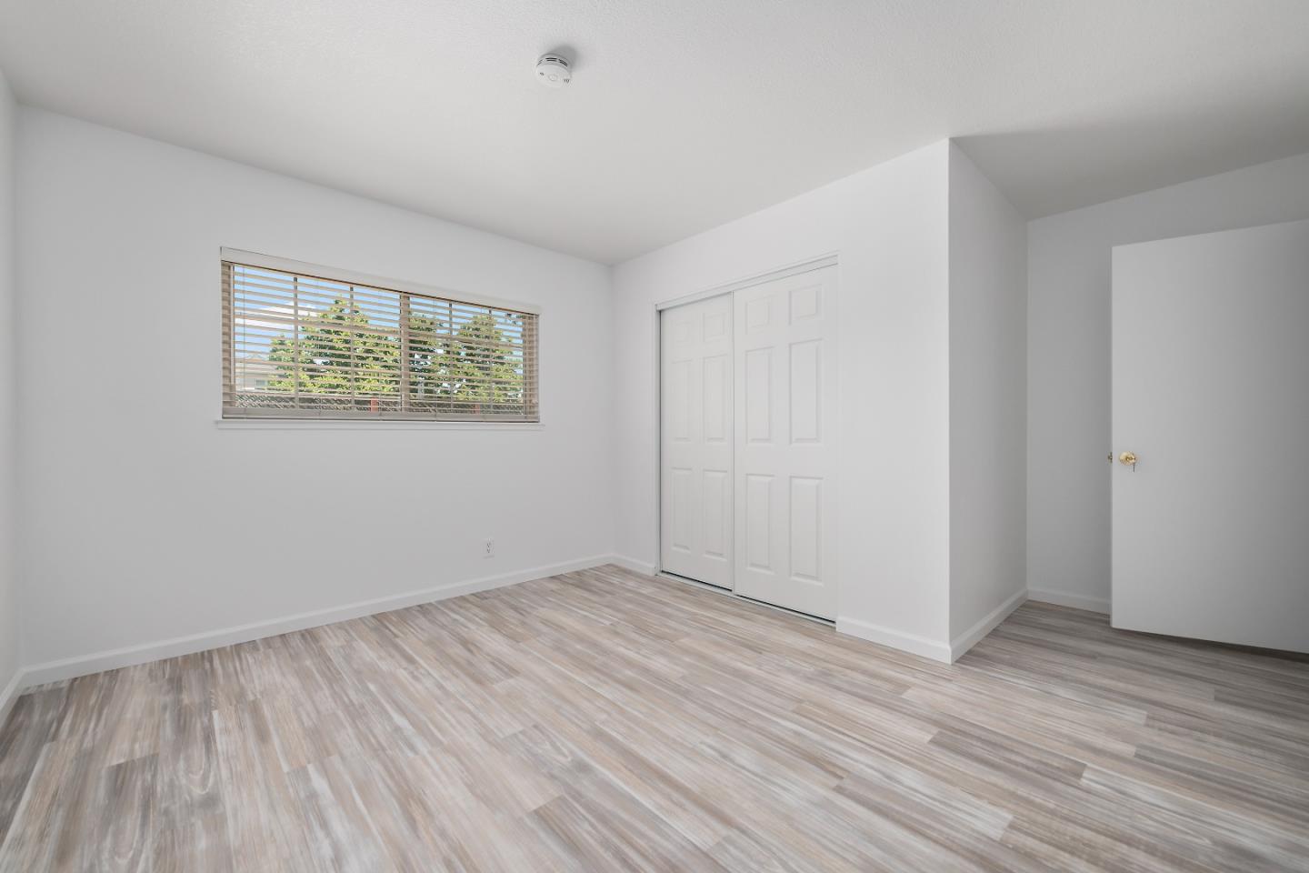 929 Maclay Drive San Jose, CA 95123 - Photo 19 of 23 an empty room with wooden floor and windows
