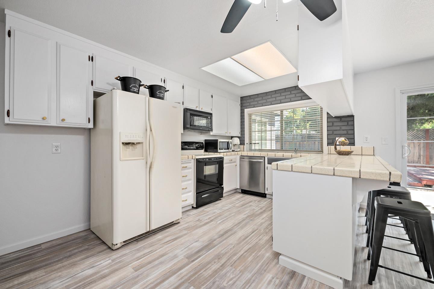 929 Maclay Drive San Jose, CA 95123 - Photo 8 of 23 a kitchen with a refrigerator a stove and a wooden floor