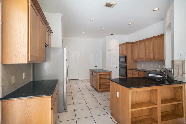 a kitchen with a sink a stove and cabinets