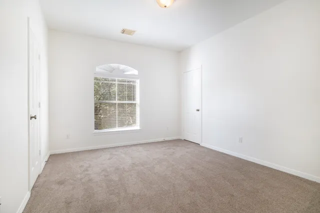a bathroom with a granite countertop sink a toilet and a mirror