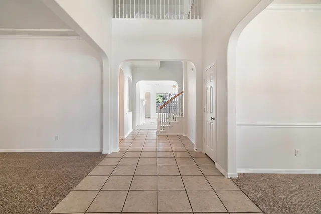 a view of a hallway view with wooden floor and staircase
