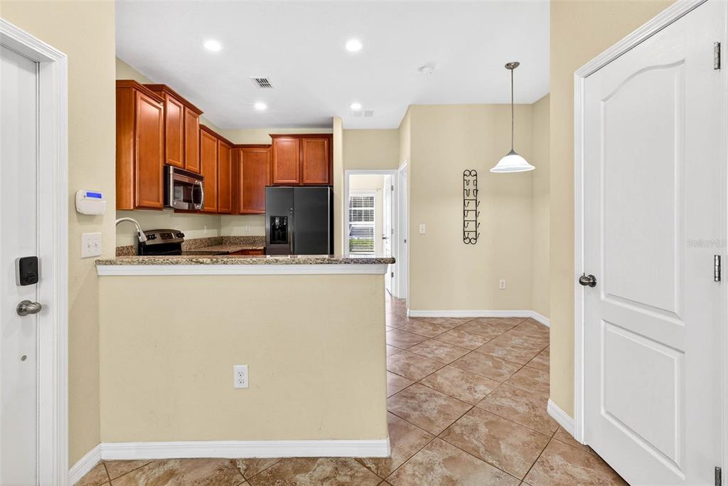 31253 Claridge Place Wesley Chapel, FL 33543 - Photo 11 of 37 a view of kitchen with stainless steel appliances granite countertop a refrigerator a oven and a sink with granite countertops