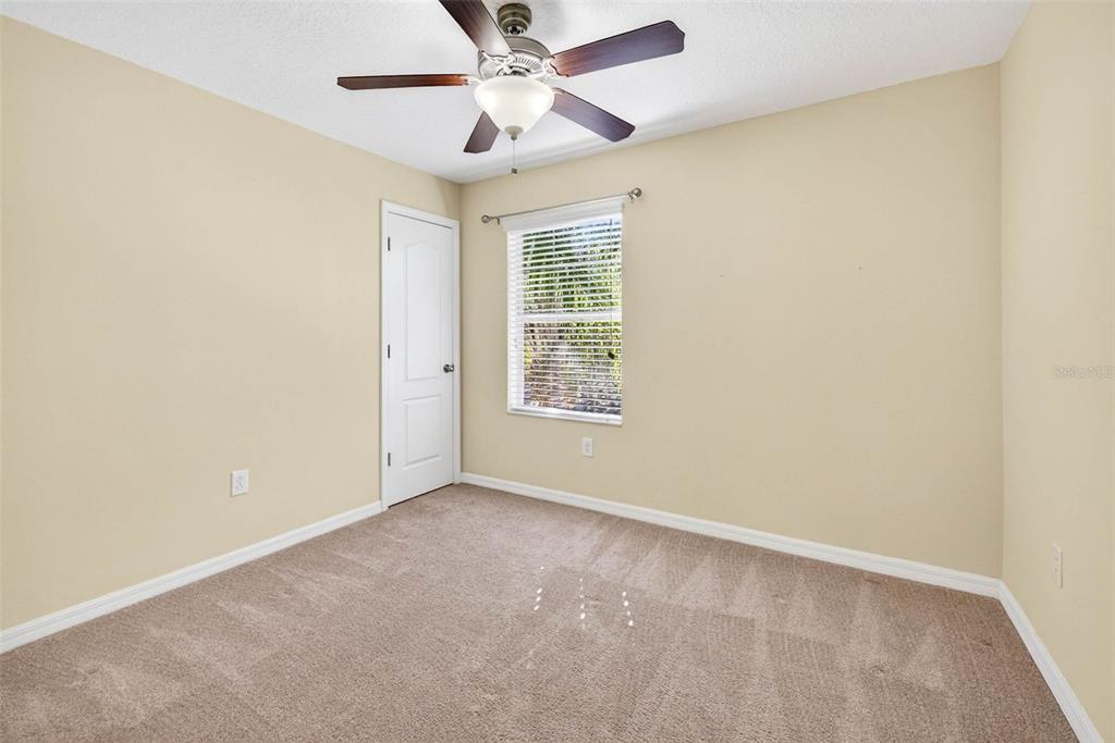 31253 Claridge Place Wesley Chapel, FL 33543 - Photo 30 of 37 an empty room with a window and a fan