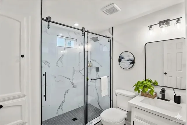 a bathroom with a shower toilet and sink