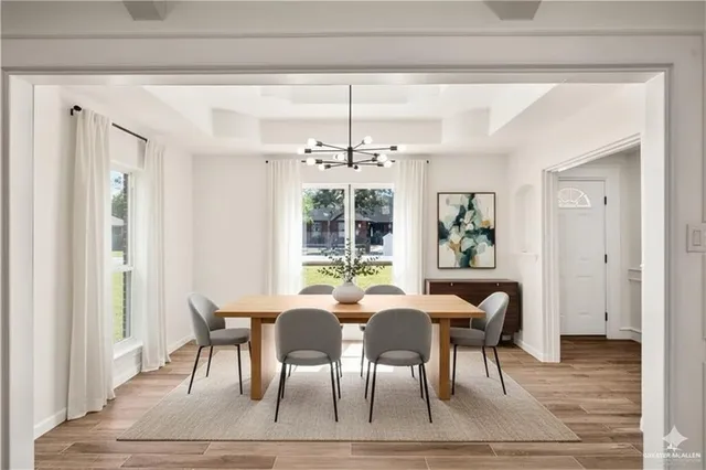 a view of a dining room with furniture wooden floor and chandelier