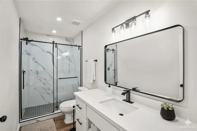 a bathroom with a sink toilet and shower