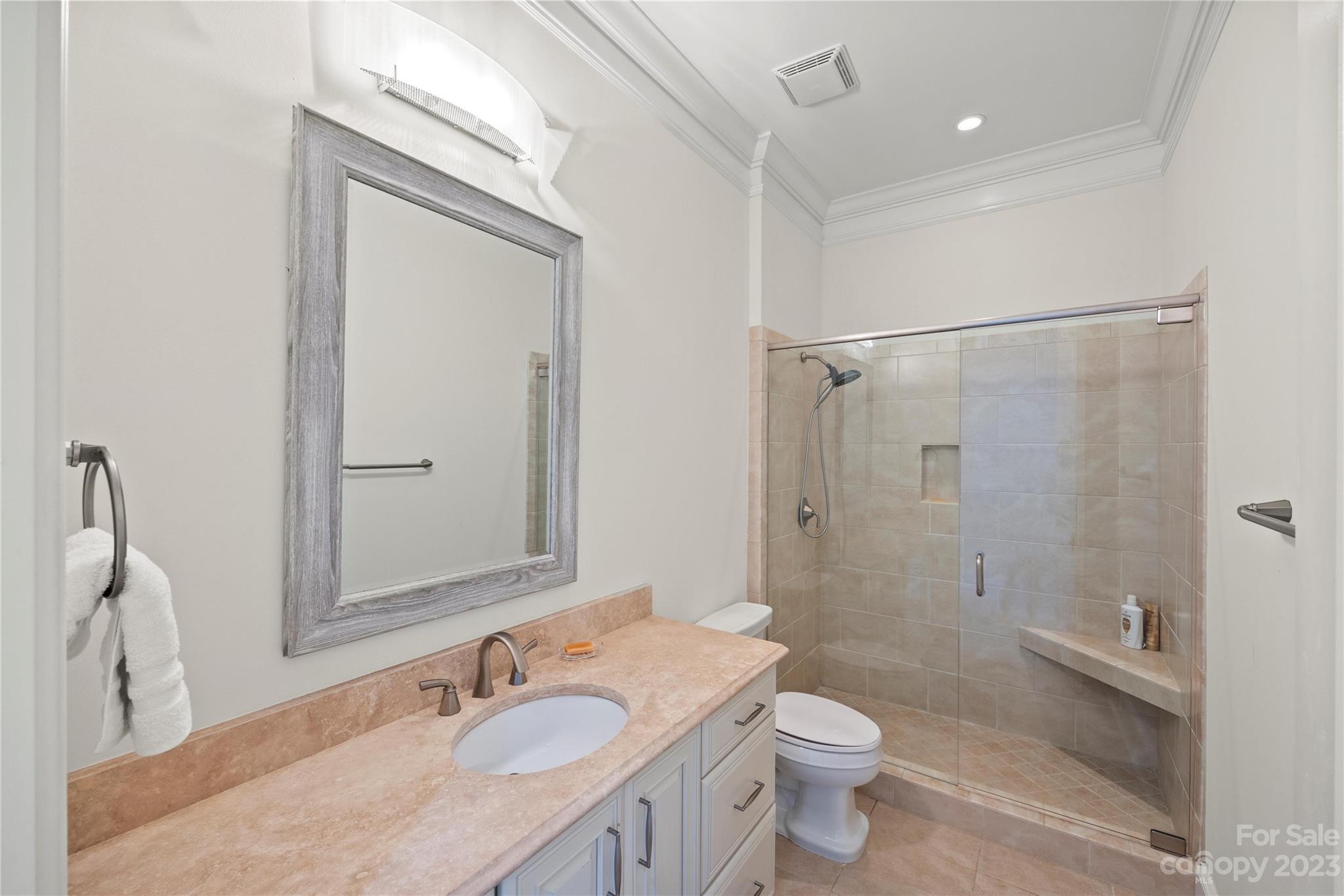2823 Providence Road, Unit 174 Charlotte, NC 28211 - Photo 22 of 38 a bathroom with a granite countertop sink a toilet and shower