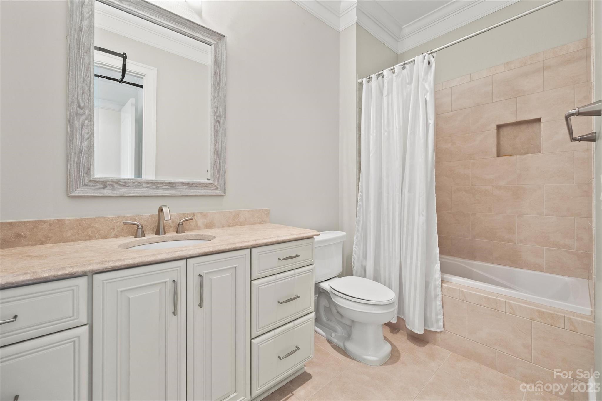 2823 Providence Road, Unit 174 Charlotte, NC 28211 - Photo 25 of 38 a bathroom with a granite countertop sink a toilet and a mirror