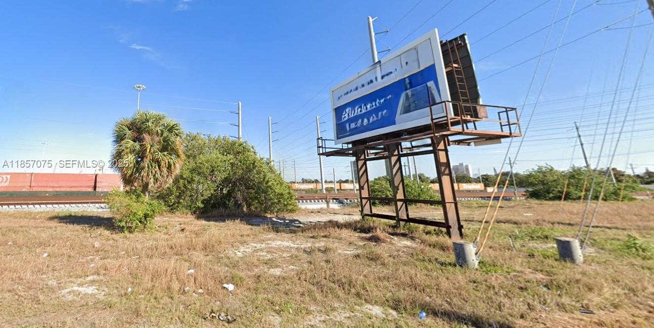 0 Old Dixie Highway Riviera Beach, FL 33404 - Photo 2 of 11 a view of a street with potted plants in front of it
