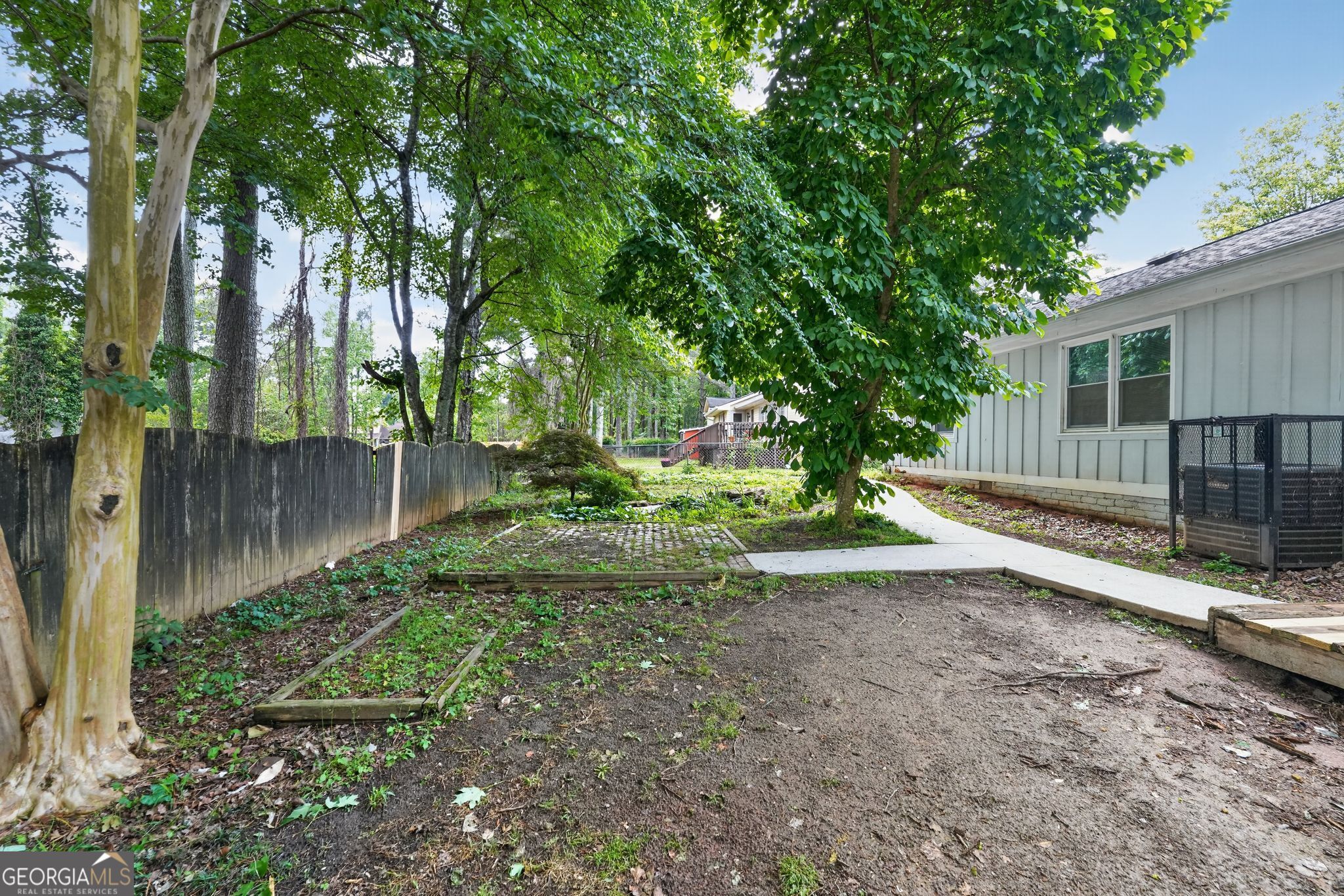 3285 Old Salem Road Southeast Conyers, GA 30013 - Photo 3 of 33 a view of a yard with plants and a large tree