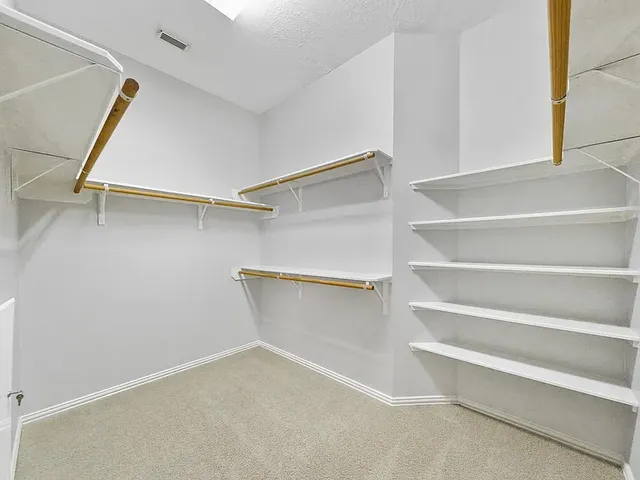 an empty room with windows and ceiling fan view