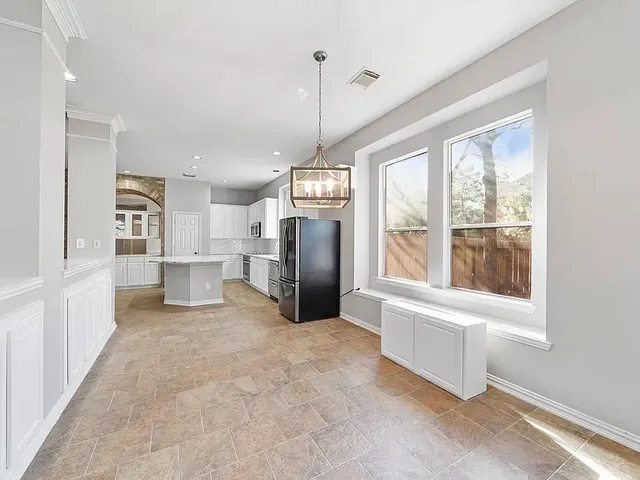 a bathroom with a granite countertop sink a toilet and bathtub